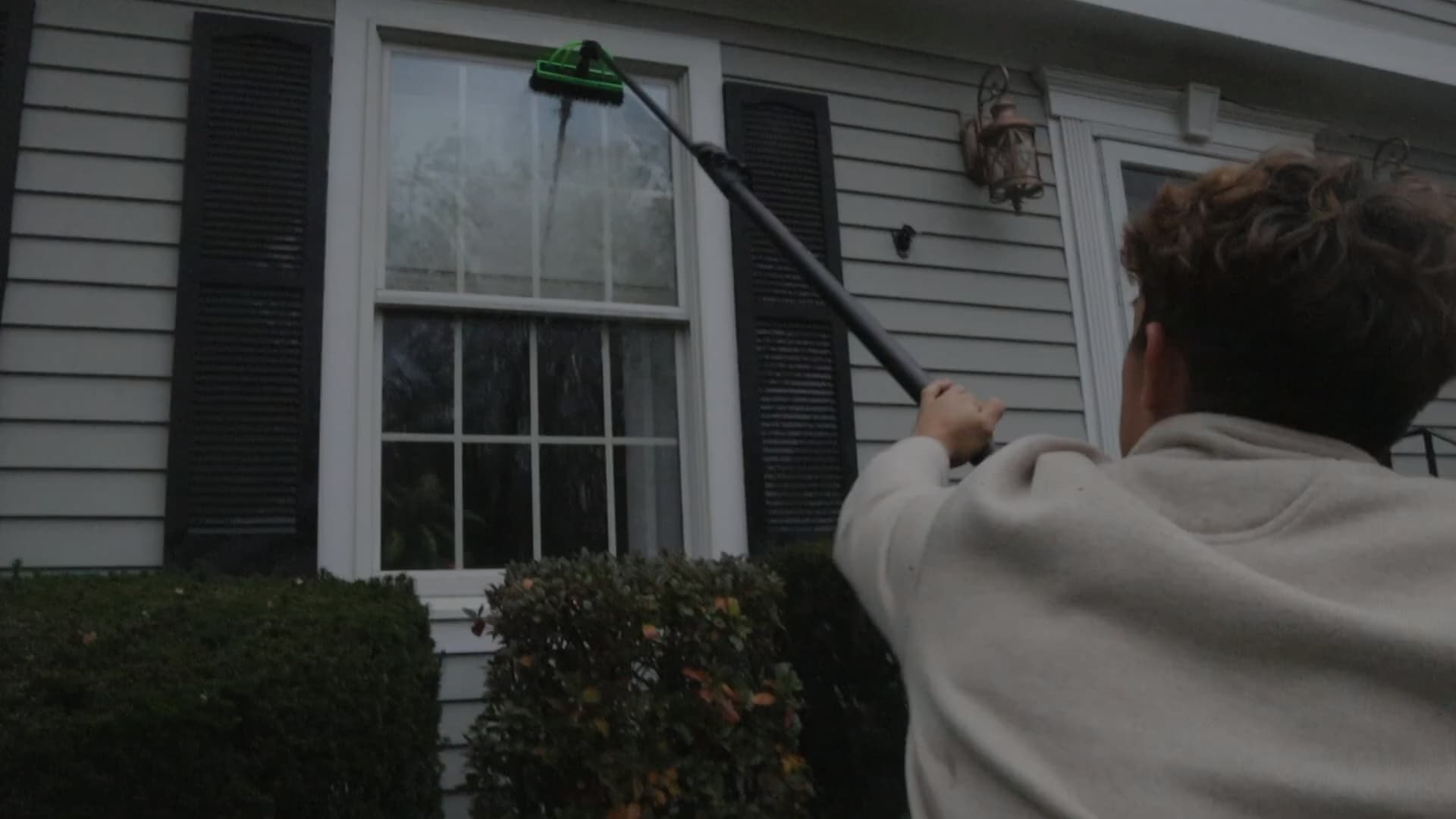 Clear Coast Pro technician cleaning a tall window with a pure-water pole